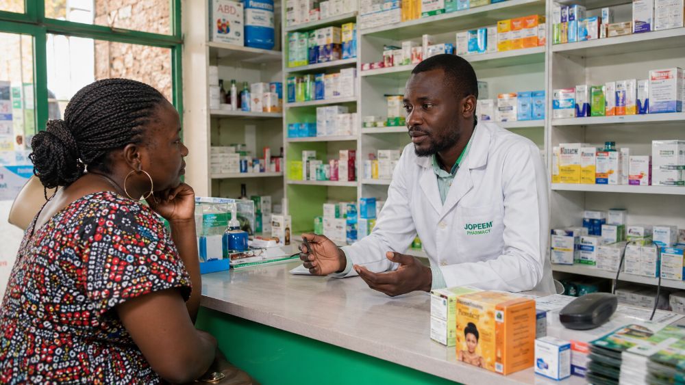 Pharmacist speaking with a customer during a consultation